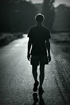 Picture looking at back of man walking down street representing Evan Black domain name.