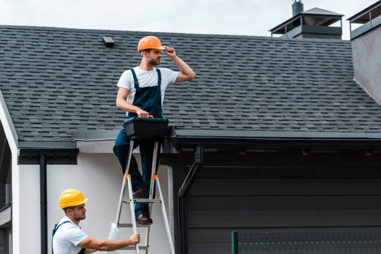 Delta roofer inspecting roof.