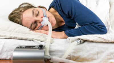 Woman sleeping with a Calgary CPAP breathing device.
