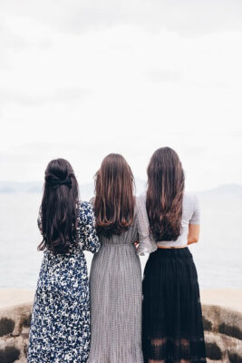 Heather Downing and two other women standing on pier looking out to ocean.