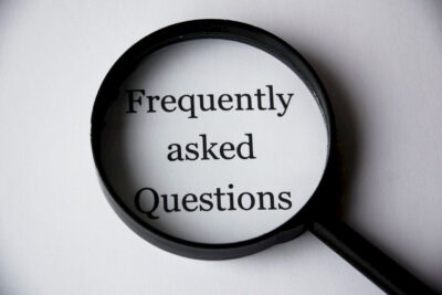 Magnifying glass over words Frequently asked Questions.